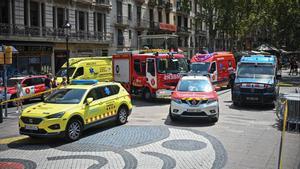 Miembros de los Bomberos y de emergencias médicas, este lunes, frente a la calle Boqueria donde se ha producido la explosión.