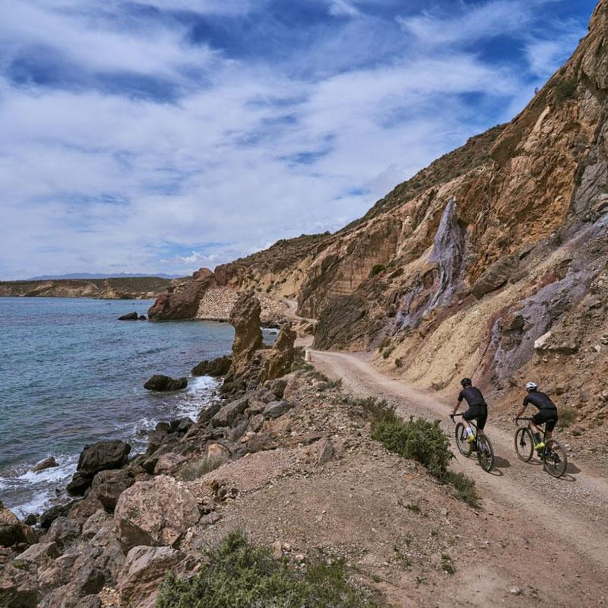 Dos ciclistas realizan un tramo en bicicleta por Mazarrón.