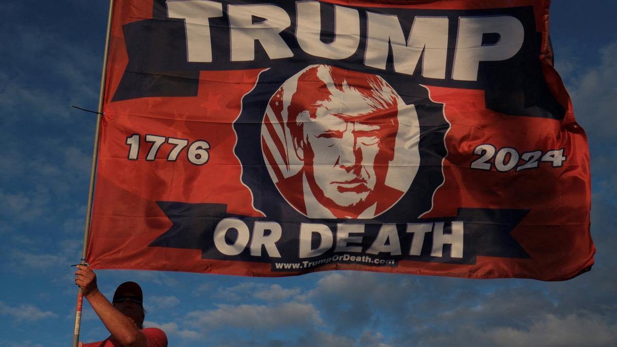 Un seguidor de Trump ondea una bandera con el lema 'Trump o muerte' en el exterior del complejo de Mar-a-Lago, esta semana en Florida.