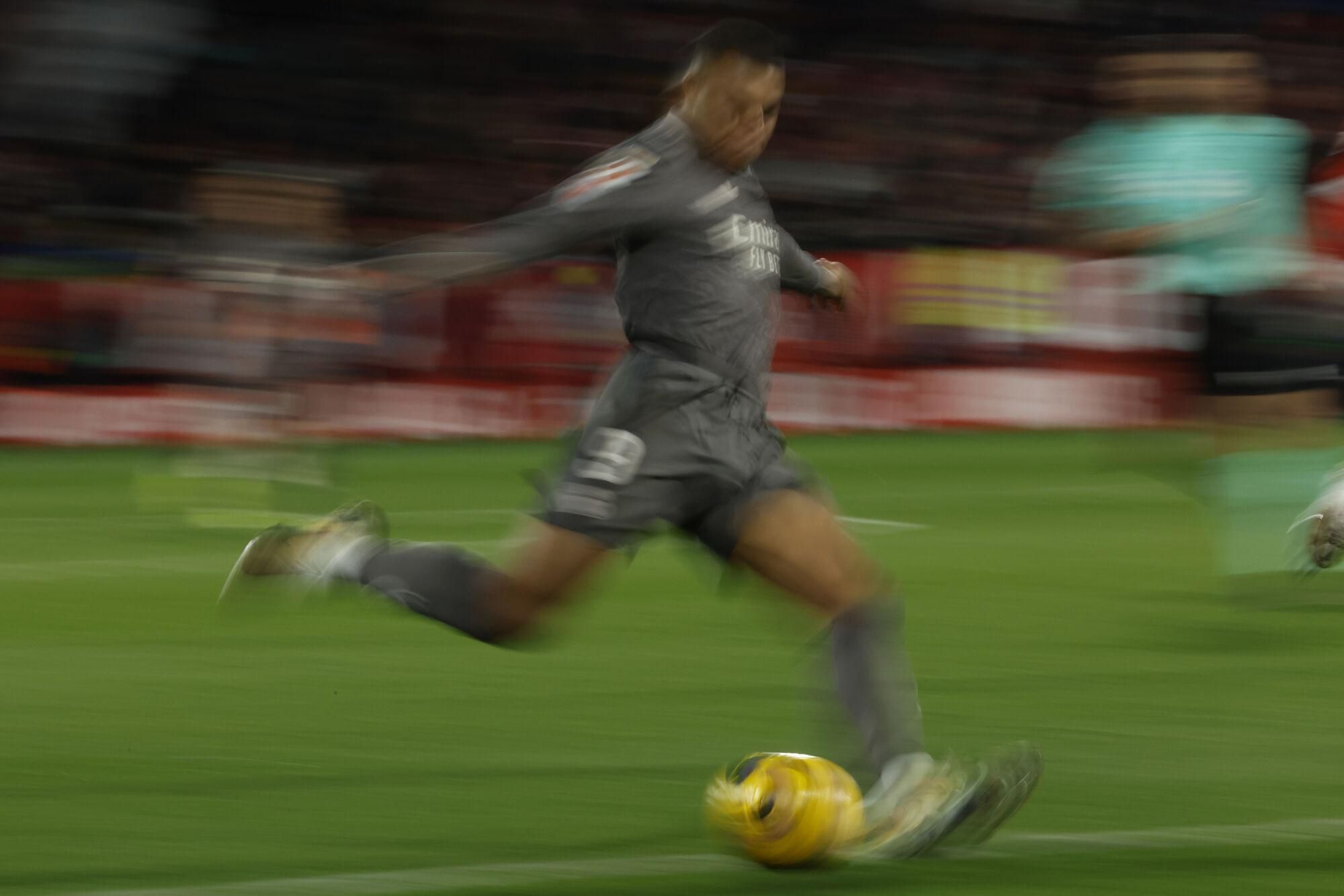 Real Madrid's Kylian Mbappe prepares to shoot during a Spanish La Liga soccer match between Girona and Real Madrid at the Montilivi stadium in Girona, Spain, Saturday, Dec. 7, 2024. (AP Photo/Joan Monfort)