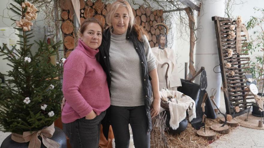 Esther Rey y Ramona Pérez con el belén realizado a tamaño real en Cerceda. |  LOC