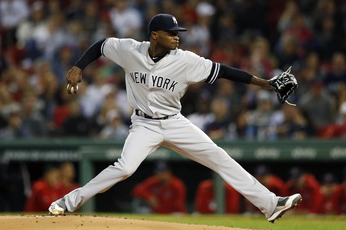 FILE - In this Sept. 6, 2019, file photo, New York Yankees’ Domingo German pitches during the first inning of the team’s baseball game against the Boston Red Sox, in Boston.  Yankees pitcher Domingo German will miss the first 63 games of the 2020 season as part of an 81-game ban for violating Major League Baseballâs domestic violence policy. The league announced the suspension Thursday, Jan. 2, 2020. German has agreed not to appeal. (AP Photo/Michael Dwyer, File)