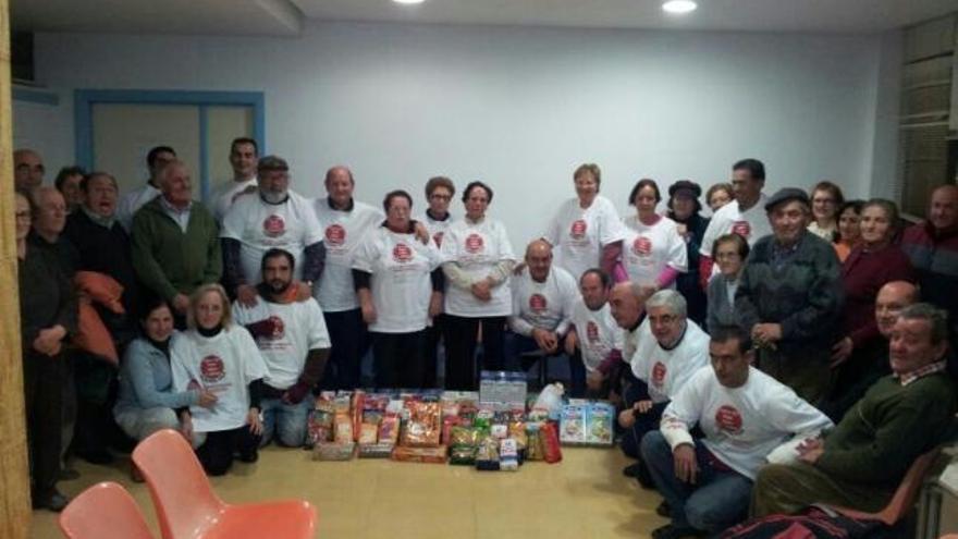 Los miembros de la plataforma posan junto al lote de alimentos recogido.