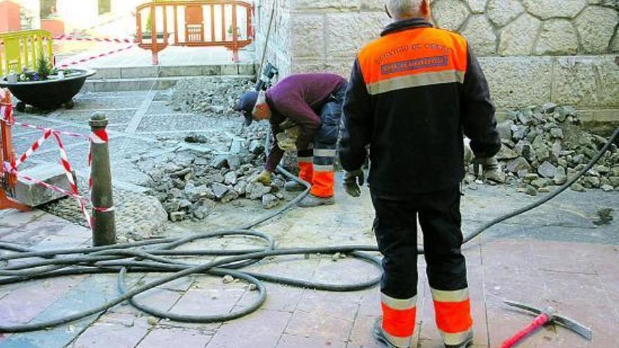 Operarios del servicio de obras del Ayuntamiento de Ribadesella, construyendo la rampa de acceso a la iglesia.