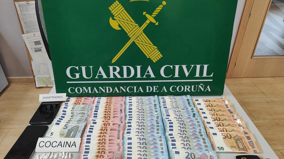 La cocaína incautada en Ribeira, junto a los móviles y el dinero en efectivo intervenidos al detenido.