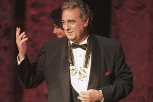 FILE - In this Tuesday, Sept. 14, 1999 file photo, Placido Domingo acknowledges the audience after receiving the 1999 Hispanic Heritage Award at the John F. Kennedy Center for the Performing Arts in Washington. An evening before a performance of âLe Cid,â part of the Washington Operaâs 1999-2000 season, opera singer Angela Turner Wilson said she and Domingo were having their makeup done together when he rose from his chair, stood behind her and put his hands on her shoulders. As she looked at him in the mirror, he suddenly slipped his hands under her bra straps, she said, then reached down into her robe and grabbed her bare breast. It hurt, she told The Associated Press. âIt was not gentle. He groped me hard.â She said Domingo then turned and walked away, leaving her stunned and humiliated. (AP Photo/Leslie Kossoff)