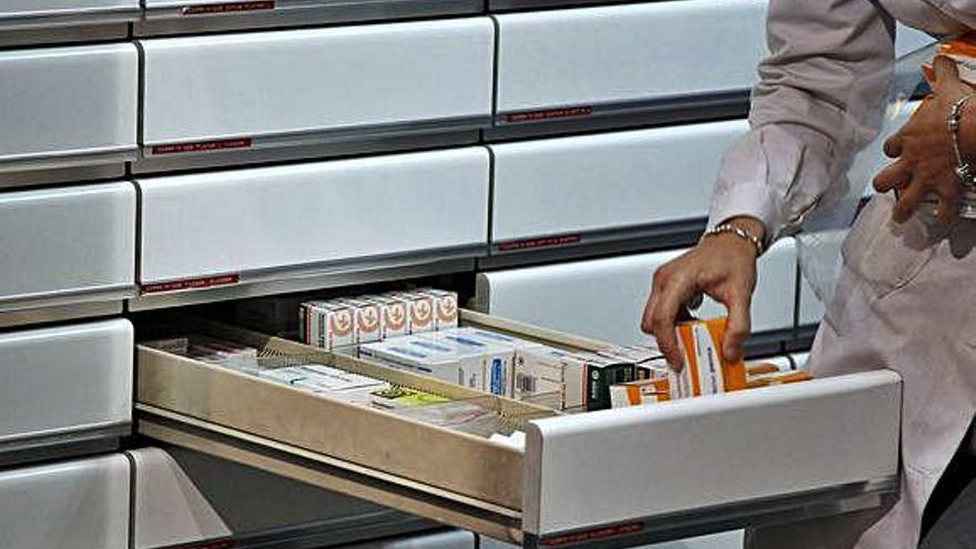 Una farmacéutica busca un medicamento.