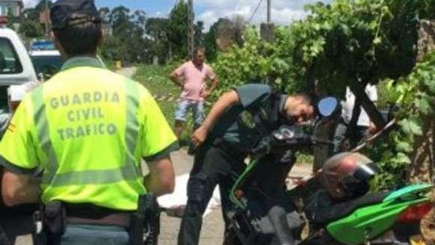 Agentes inspeccionan la motocicleta de la víctima. // FdV