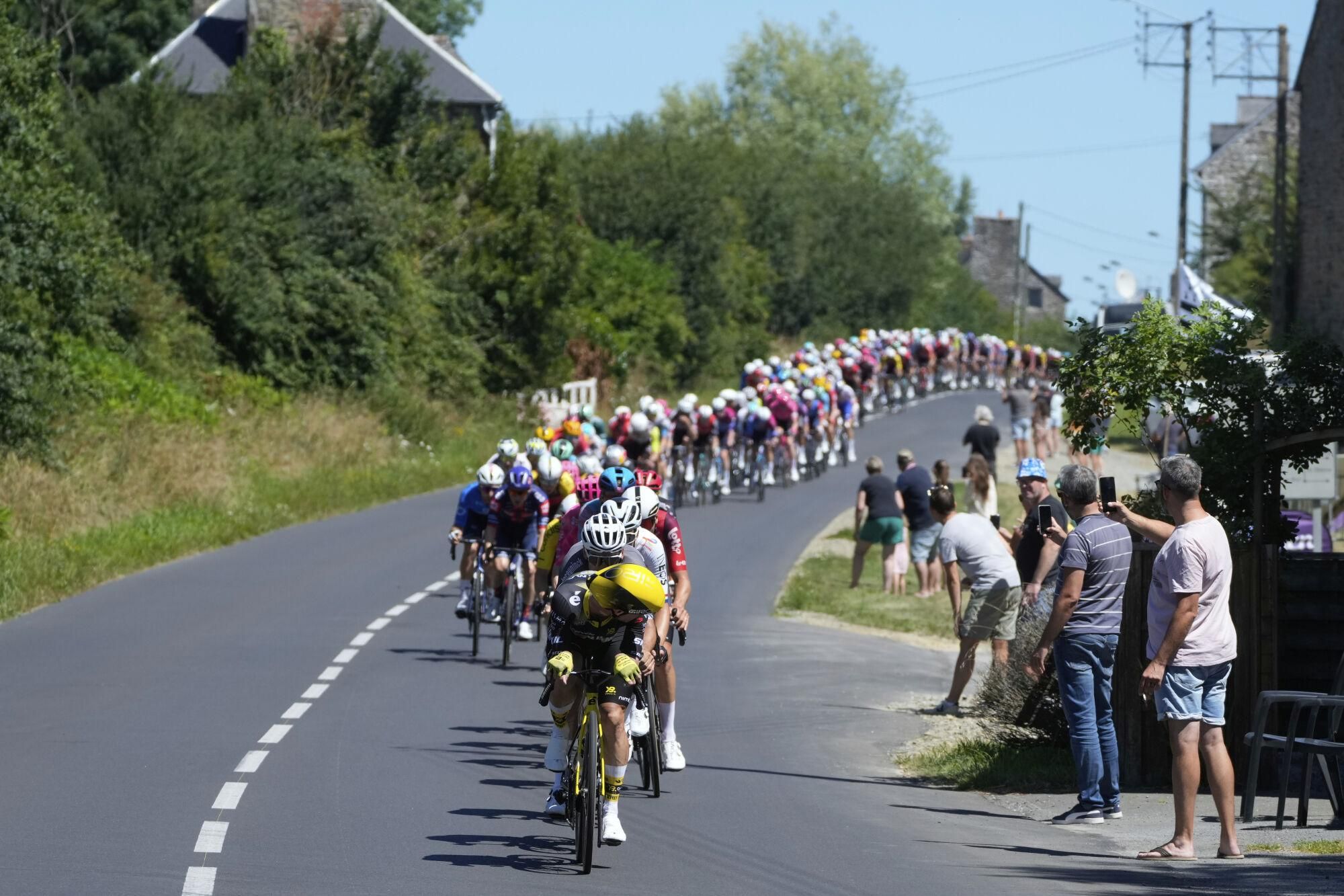 The pack rides during the seventh stage of the Tour de France cycling race over 197 kilometers (122.4 miles) with start in Saint-Malo and finish in Mur-de-Bretagne Guerledan, France, Friday, July 11, 2025. (AP Photo/Mosa'ab Elshamy)