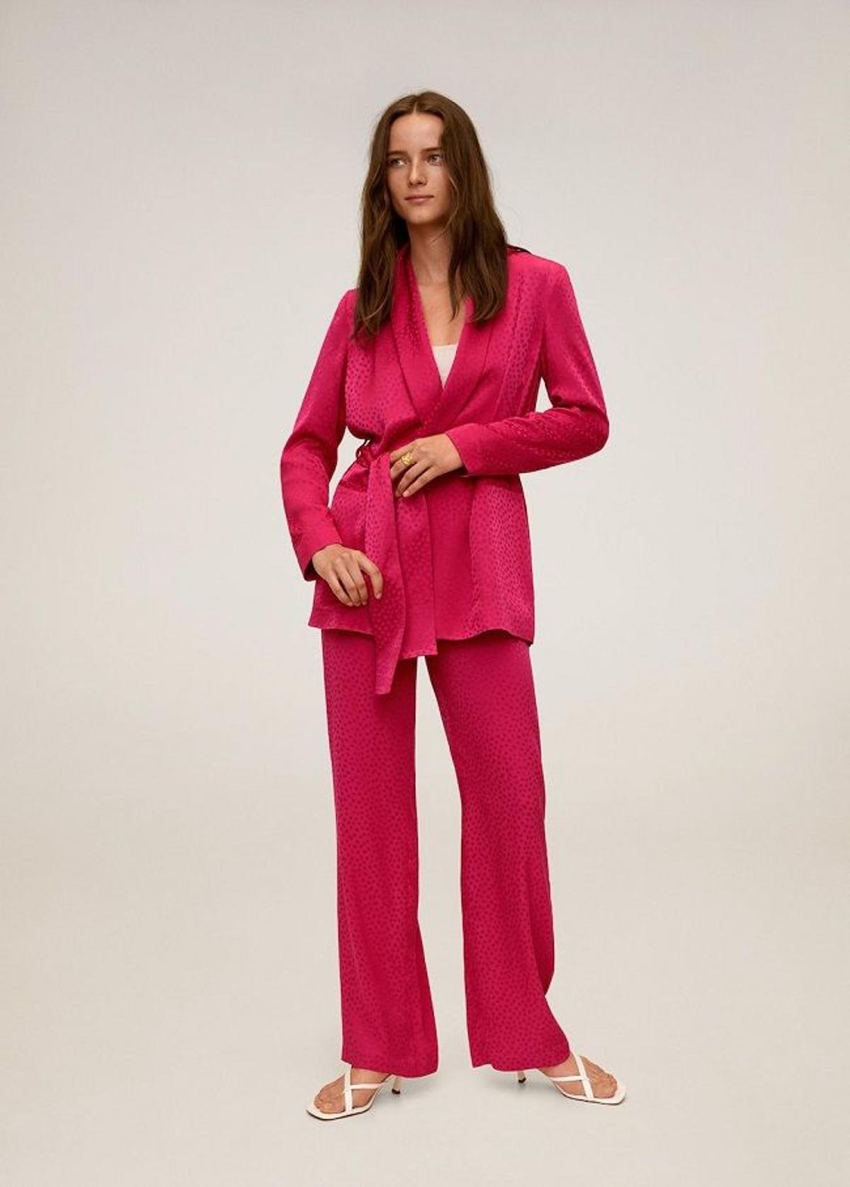 Traje satinado de color rosa fucsia con americana con lazo y pantalón ancho, de Mango