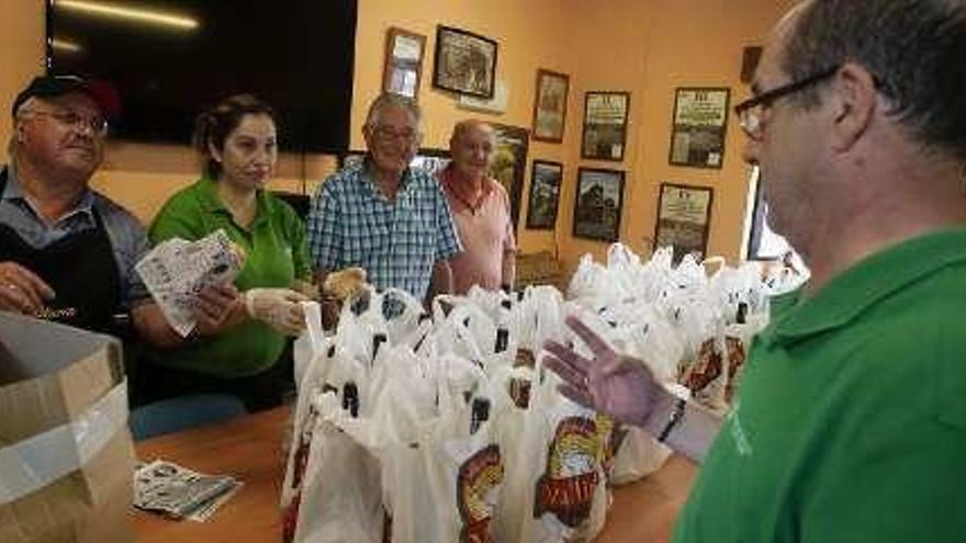 Socios recogiendo el bollo y el vino.