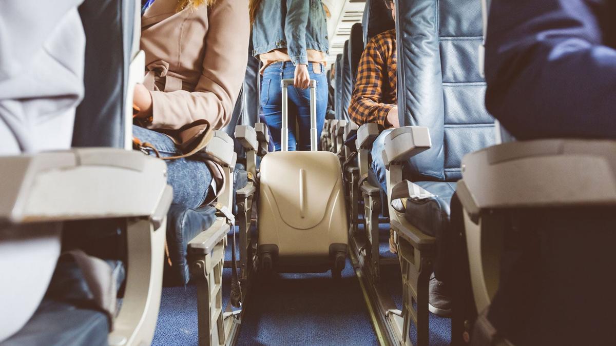 Interior of airplane with people sitting on seats