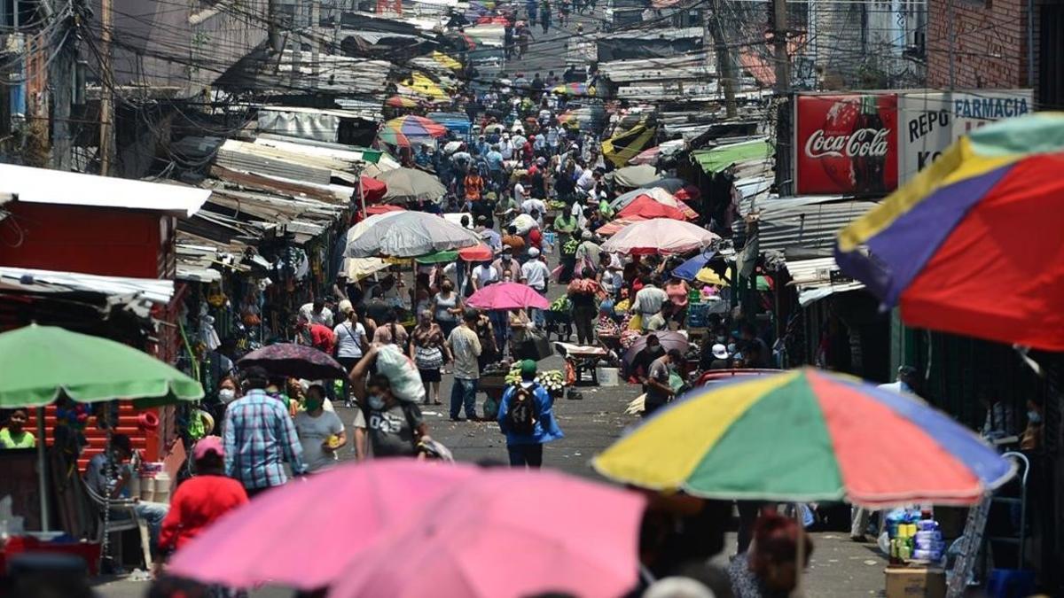 undefined53020825 people shop at a crowded market in tegucigalpa on april 3  2200403210200