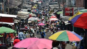 undefined53020825 people shop at a crowded market in tegucigalpa on april 3  2200403210200