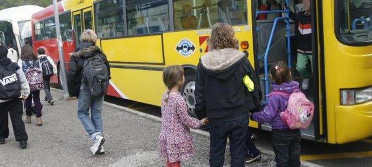 Niños accediendo al transporte escolar.