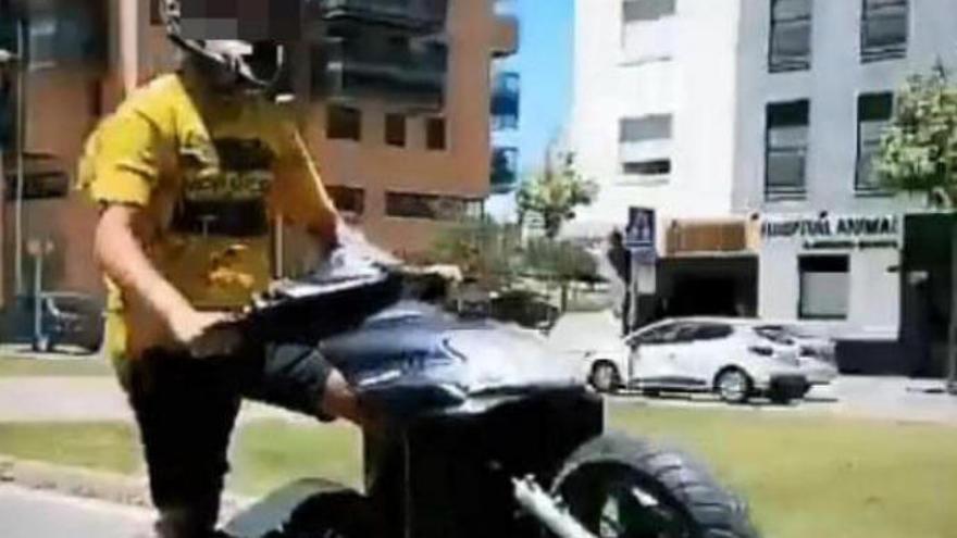 El detenido haciendo el caballito con un ciclomotor.