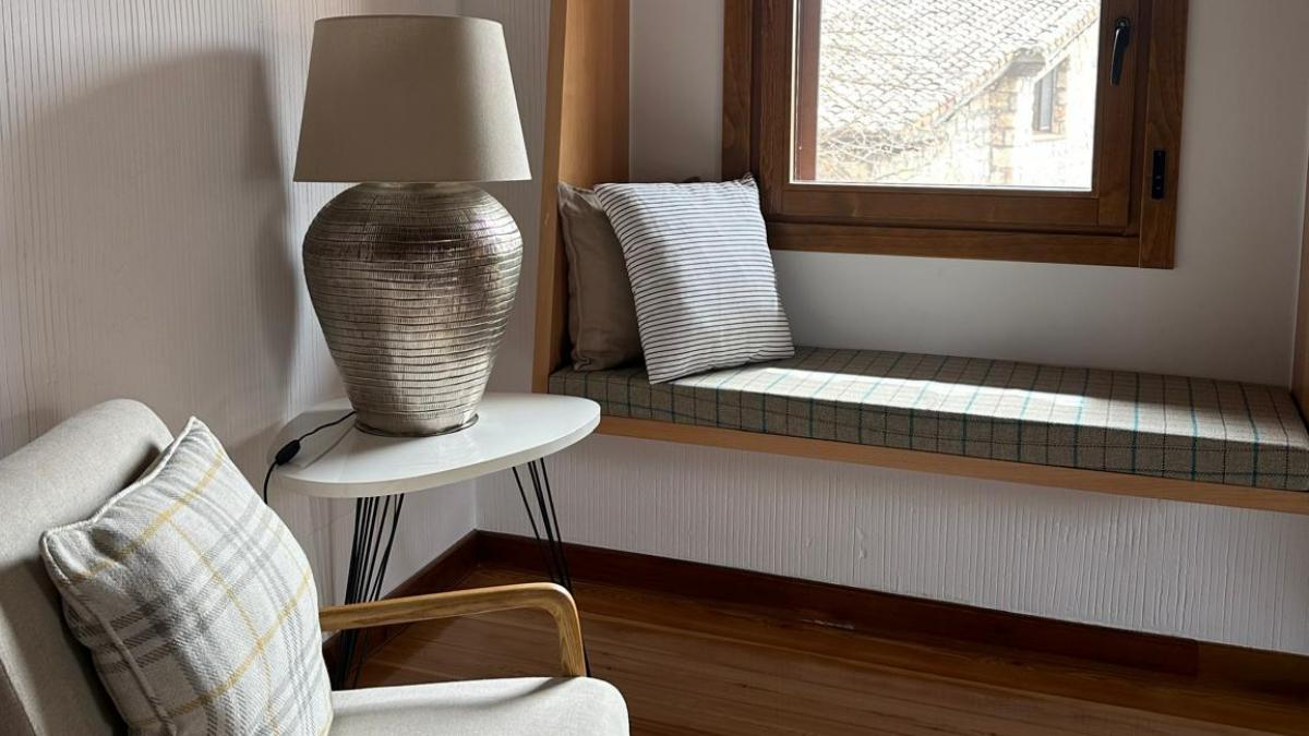 La habitación de Molino de Alcuneza prolonga la calma del entorno: piedra, madera, luz natural y una hospitalidad pensada para descansar sin prisa.