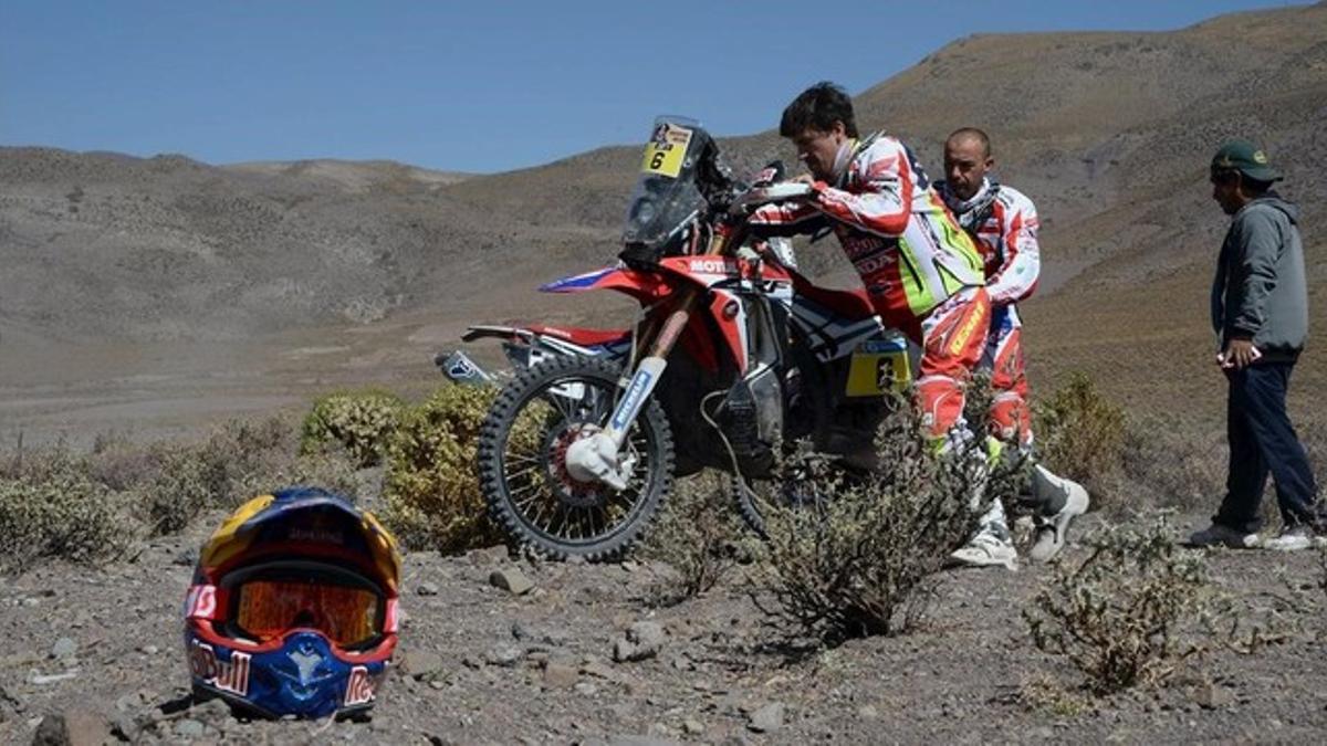 Joan Barreda, auxiliado por su compañero de equipo Paolo Ceci después de que se rompiera el motor de su Honda en la etapa del Dakar del viernes.