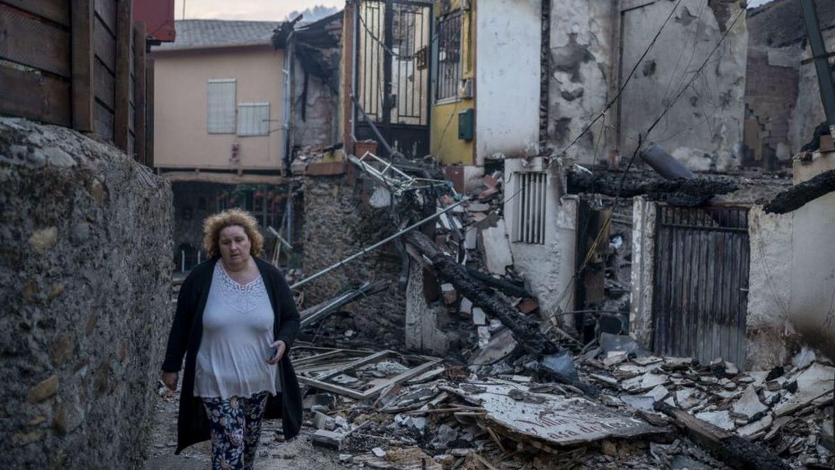 Una vecina camina por A Veiga da Cascallá.