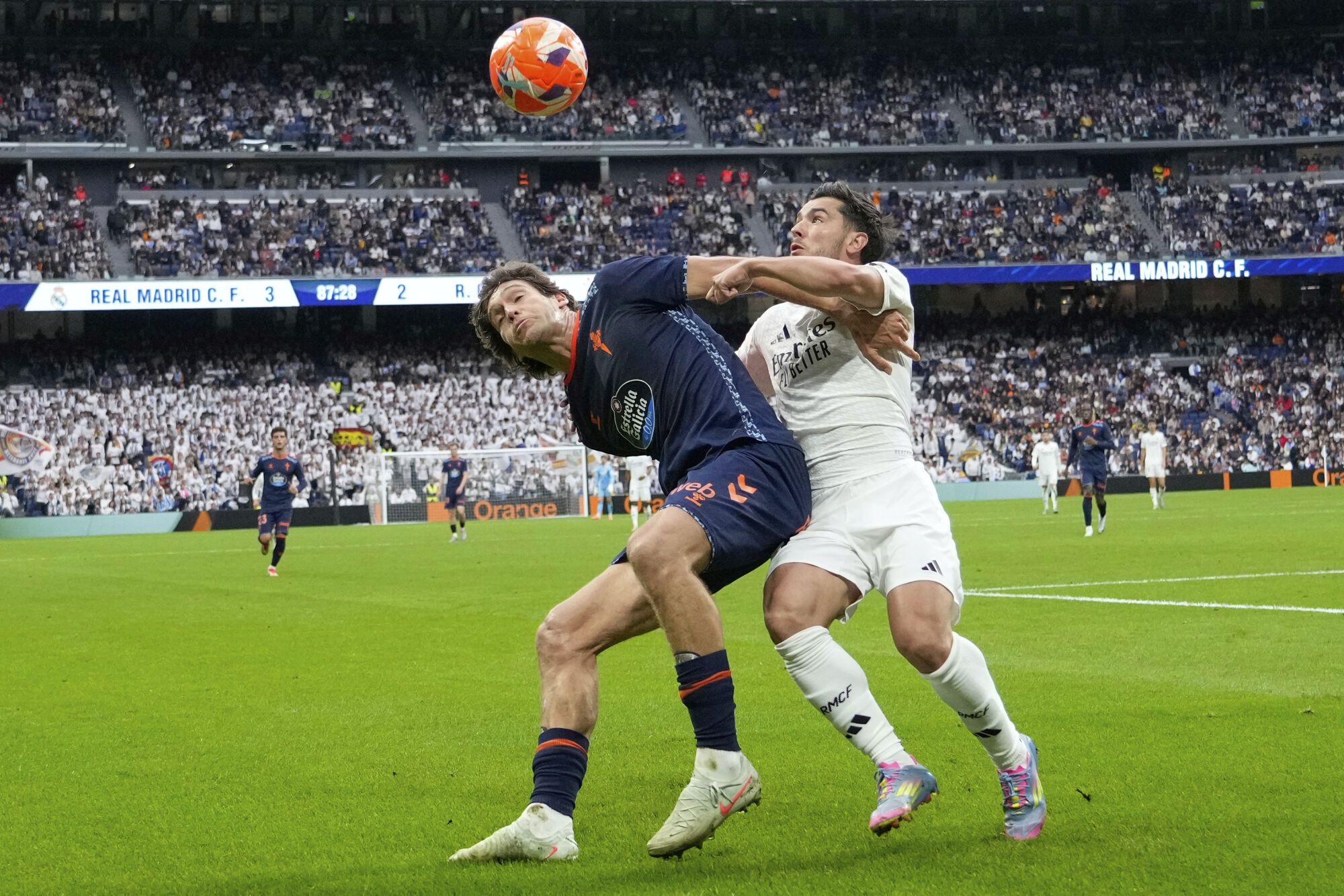 Celta's Marcos Alonso, left, challenges for the ball with Real Madrid's Brahim Diaz during the Spanish La Liga soccer match between Real Madrid and Celta Vigo at the Santiago Bernabeu stadium in Madrid, Spain, Sunday, May 4, 2025. (AP Photo/Jose Breton)