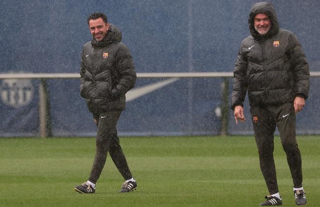 Xavi y Òscar Hernández, ríen bajo la lluvia durante durante el entrenamiento del sábado.