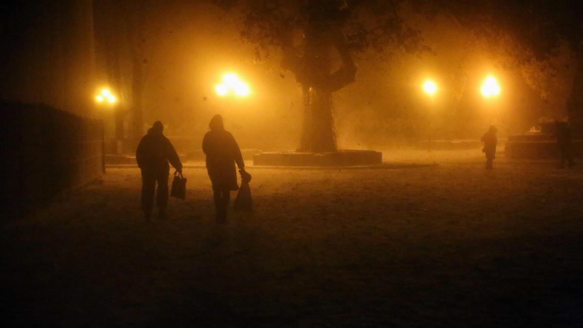 Ciudadanos ucranianos caminando en la ciudad de Odesa durante una tormenta.