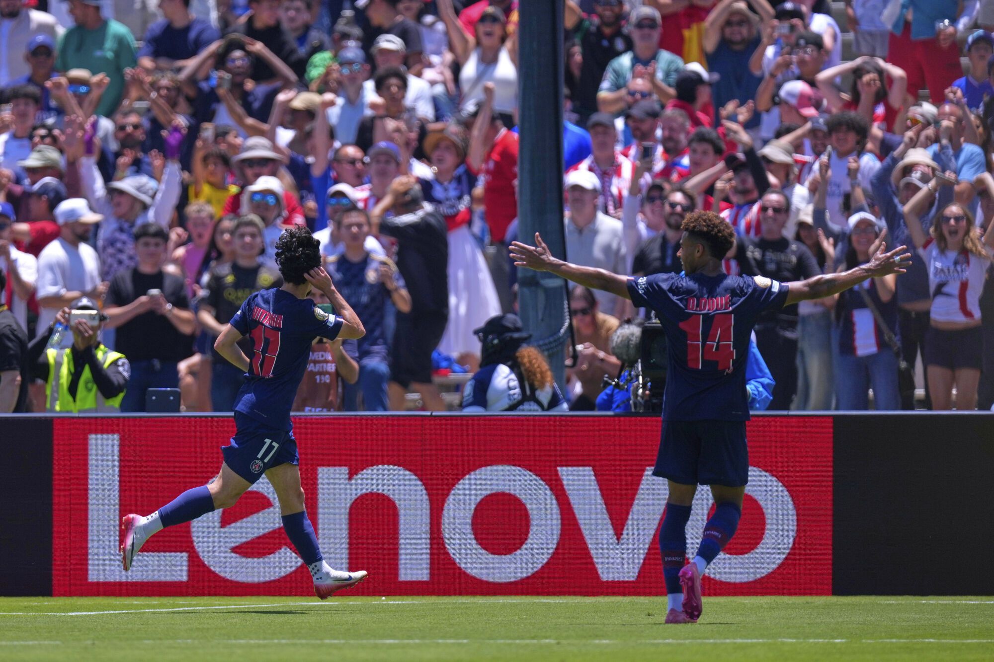 Paris Saint-Germain's Vitinha, left, celebrates with teammates after scoring his side's second goal during the Club World Cup group B soccer match between PSG and Atletico Madrid, in Pasadena, Calif., Sunday, June 15, 2025. (AP Photo/Mark J. Terrill)