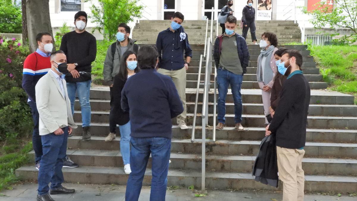 Estudiantes y secretario xeral conversando ayer en el campus de Ourense. // FERNANDO CASANOVA