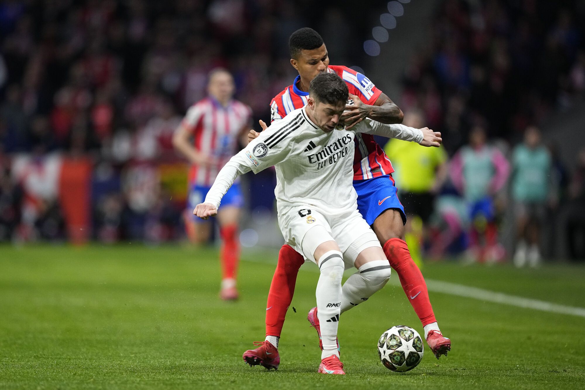 Federico Valverde of Real Madrid and Reinildo Mandava of Atletico de Madrid in action during the UEFA Champions League 2024/25  League Round of 16 Second Leg match between Atletico de Madrid and Real Madrid CF, at Riyadh Air Metropolitano stadium on March 12, 2025, in Madrid, Spain. AFP7 12/03/2025 ONLY FOR USE IN SPAIN. Oscar J. Barroso / AFP7 / Europa Press;2025;SOCCER;SPAIN;SPORT;ZSOCCER;ZSPORT;Atletico de Madrid v Real Madrid CF - UEFA Champions League 2024/25  League Round of 16 Second Leg;