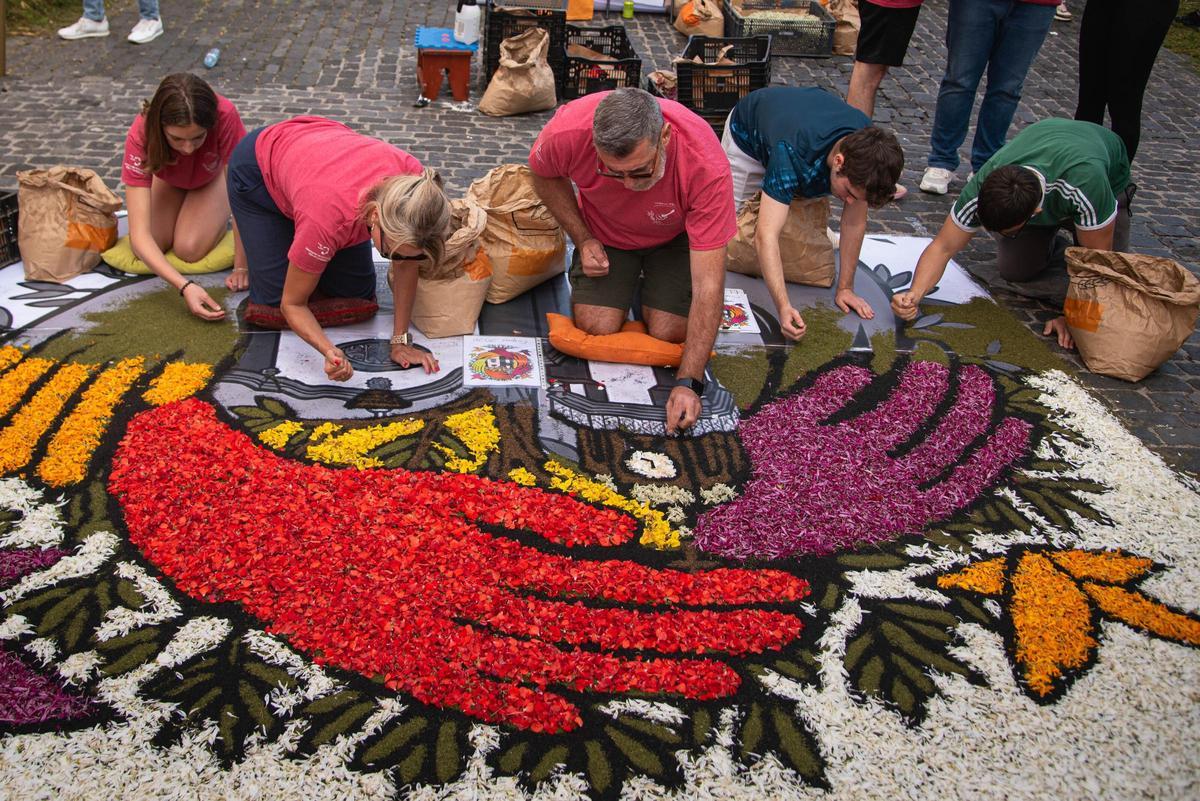 Family and friends gathered around a carpet