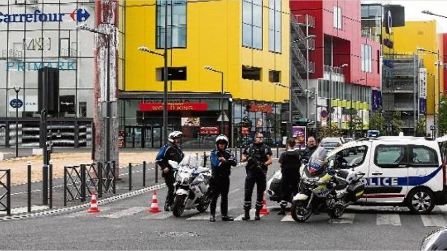 Agents de la policia participant, ahir, en les tasques de rescat dels divuit ostatges retinguts en un centre comercial.