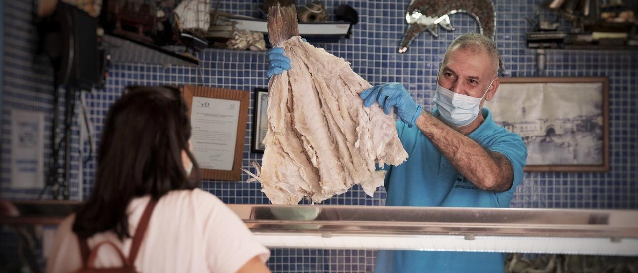 Un pescadero atiende a una cliente en el Mercado de Nuestra Señora de África.