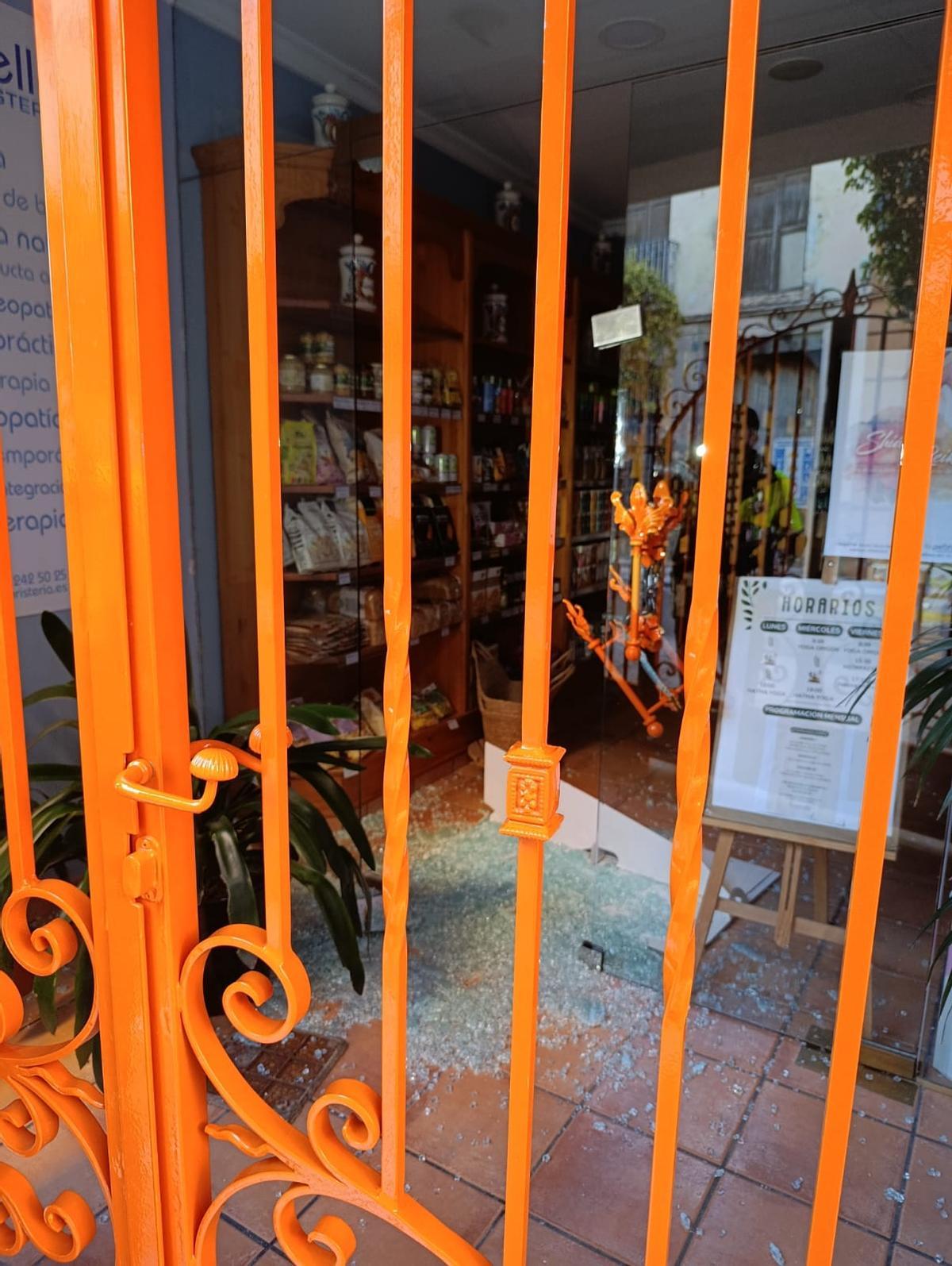 Puerta de cristal rota en el comercio que sufrió el robo.