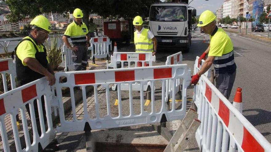 Unos operarios examinan las tuberías de Pontevedra en las que se produjo la avería. // Santos Álvarez