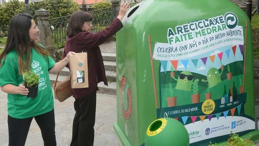 Una mujer deposita vidrio en un iglú de Ecovidrio. // Rafa Vázquez