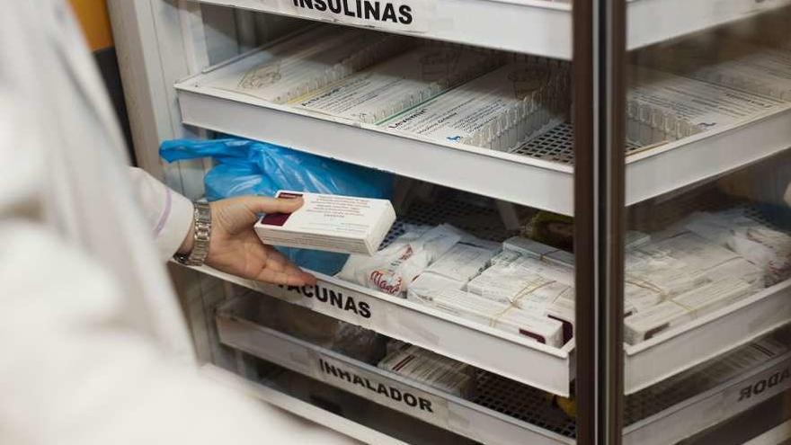 Un farmacéutico guarda unas vacunas en su establecimiento.