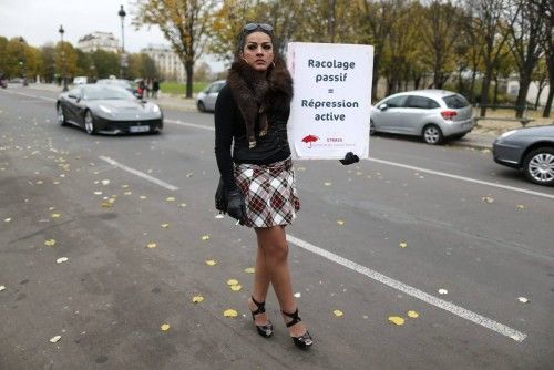 A sex worker activist attends a demonstration with prostitutes against a proposal to scrap sanctions on soliciting and instead punish prostitutes' customers with fines in Paris