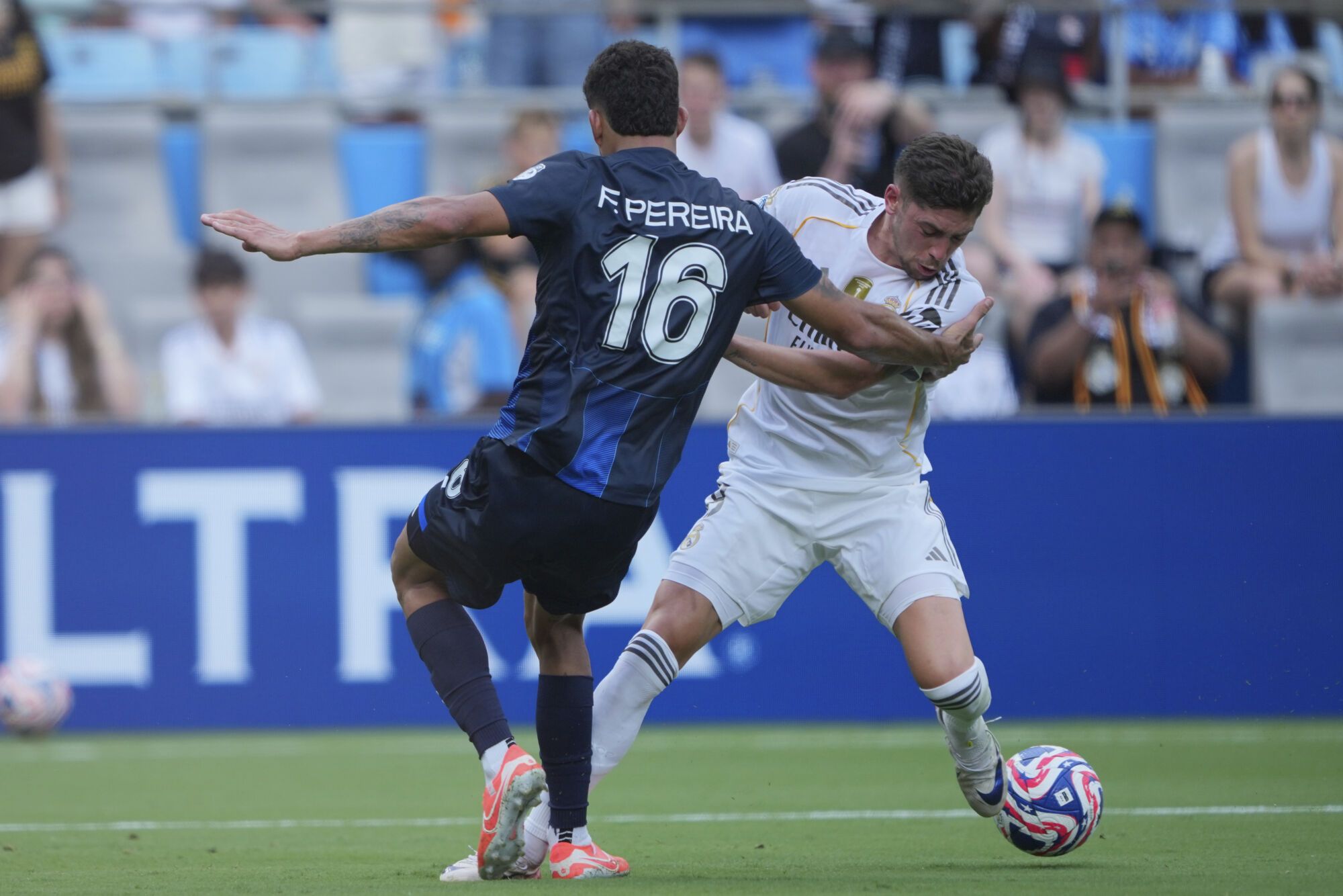 Real Madrid's Federico Valverde, right, and Pachuca's Federico Pereira battle for the ball during the Club World Cup Group H soccer match between Real Madrid and CF Pachuca in Charlotte, N.C., Sunday, June 22, 2025. (AP Photo/Chris Carlson)