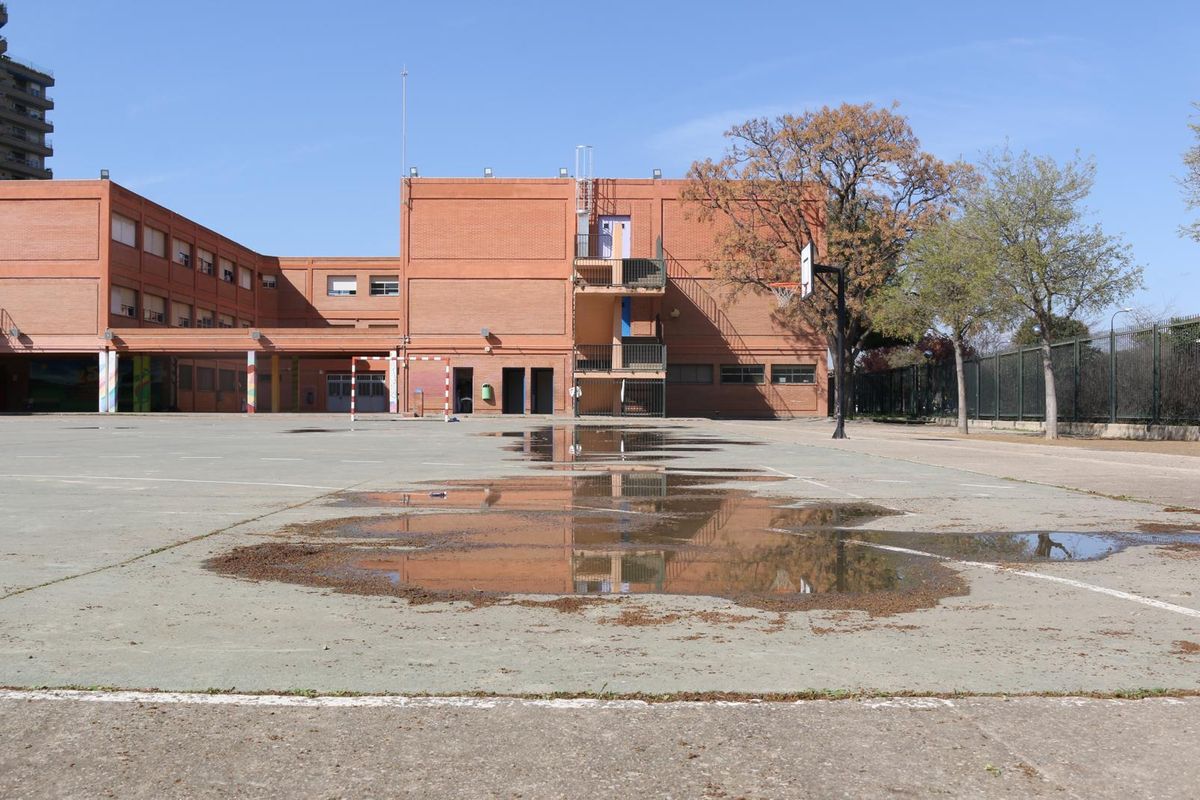 Una zona del patio del colegio Cortes de Aragón mojada.