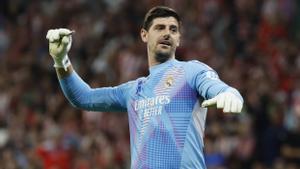 Thibaut Courtois retirando un objeto lanzado desde la grada, durante el partido de la LaLiga entre el Atlético de Madrid y Real Madrid.