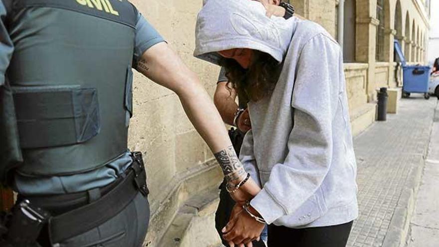 Guardias civiles trasladan, ayer, a la acusada de arrollar con el coche a la novia de su exmarido.