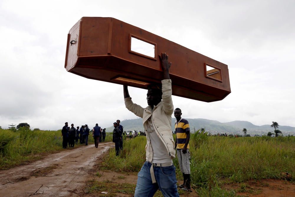 A man carries an empty coffin at the Paloko ...