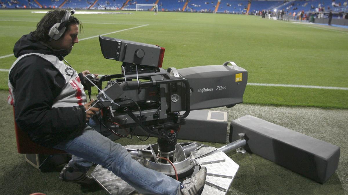 Un cámara de televisión durante un partido de fútbol.