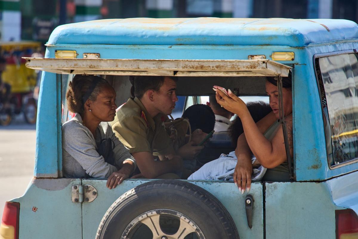 People share private transport in Havana, Cuba, Wednesday, Feb. 11, 2026. (AP Photo/Ramon Espinosa)