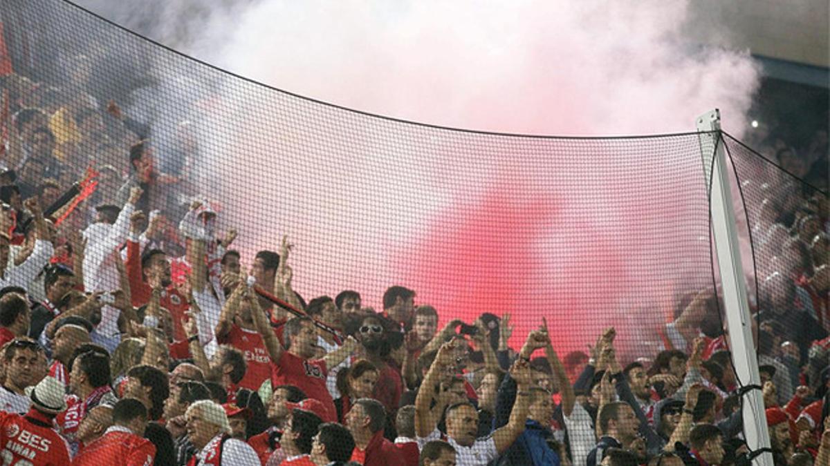 Aficionados del Benfica encienden bengalas durante el partido del Vicente Calderón