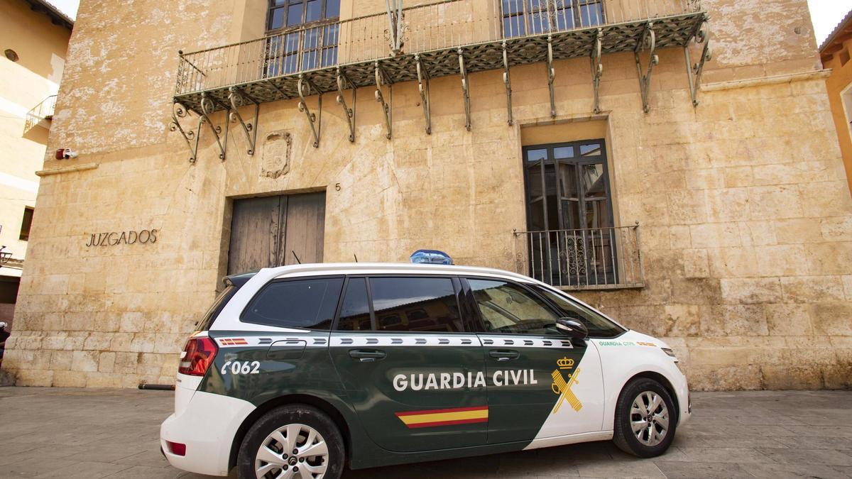 Un coche de la Guarda Civil, frente a los juzgados de Xàtiva.