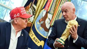 El presidente de la FIFA, Gianni Infantino (d), sostiene la Copa del Mundo y dialoga con el presidente de Estados Unidos, Donald Trump. EFE/EPA/ANNABELLE GORDON / POOL