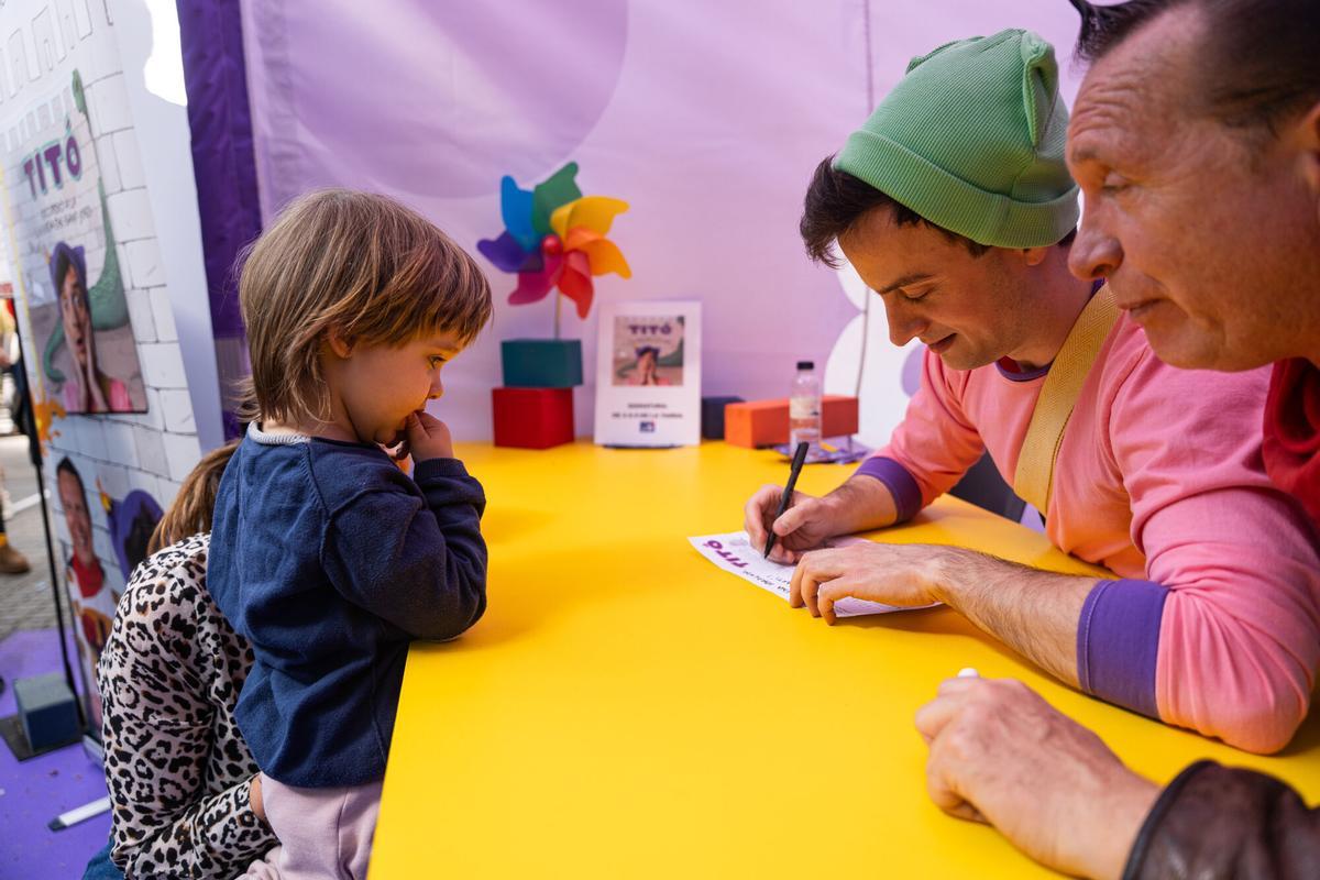 Titó i John C firman libros y láminas a los más pequeños.