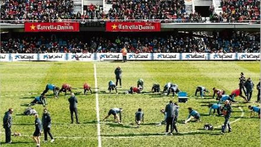 Els jugadors blaugrana realitzen estiraments davant l&#039;atenta mirada dels més de 13.000 aficionats.