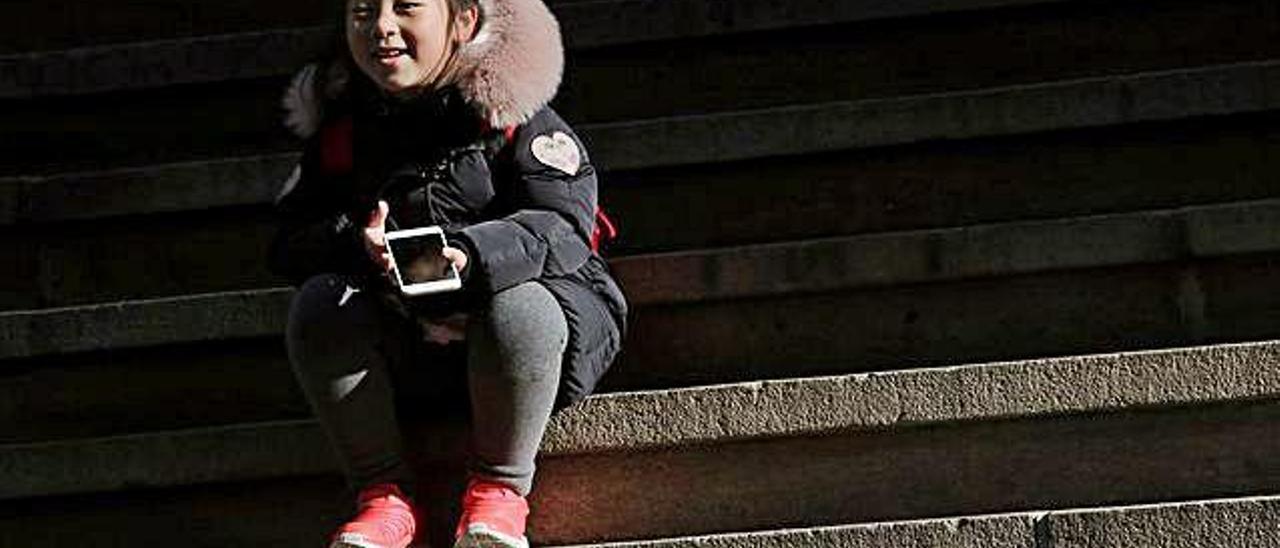 Una niña utiliza un teléfono móvil, a principios de año en Nueva York.